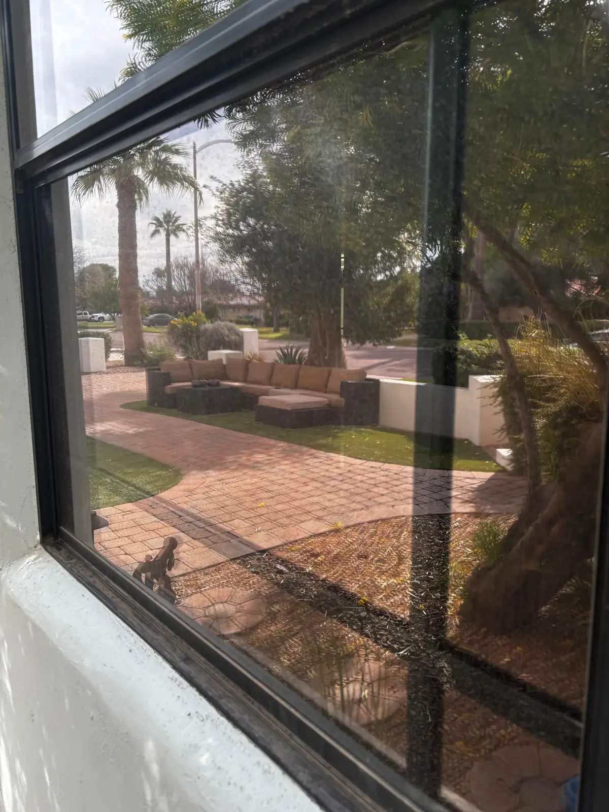 Window with hard water spots before cleaning