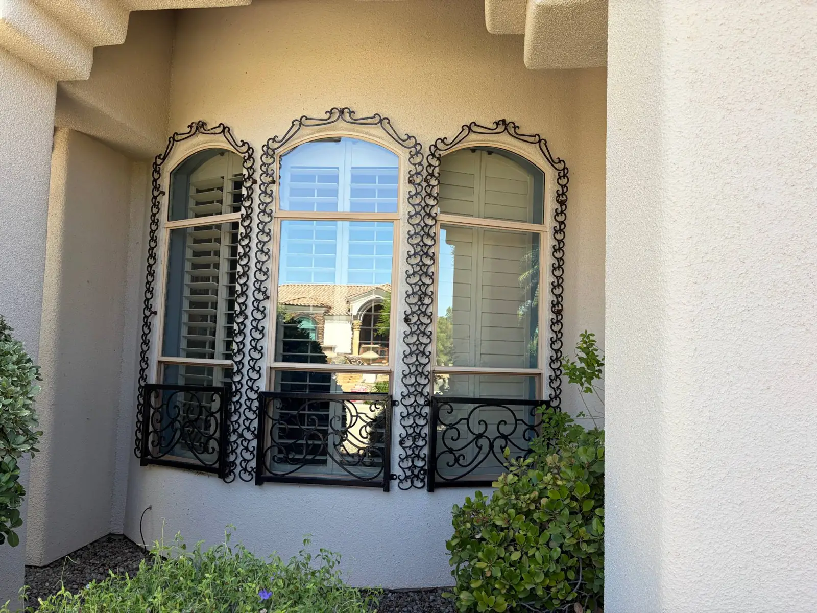 Crystal-clear arched windows with wrought-iron detail