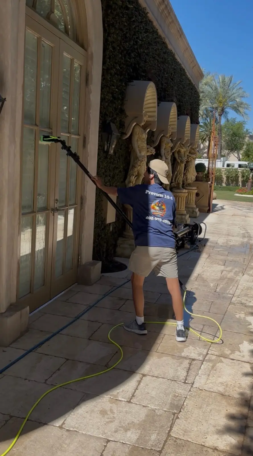 Glass Masters AZ team member cleaning windows at a luxury Phoenix estate